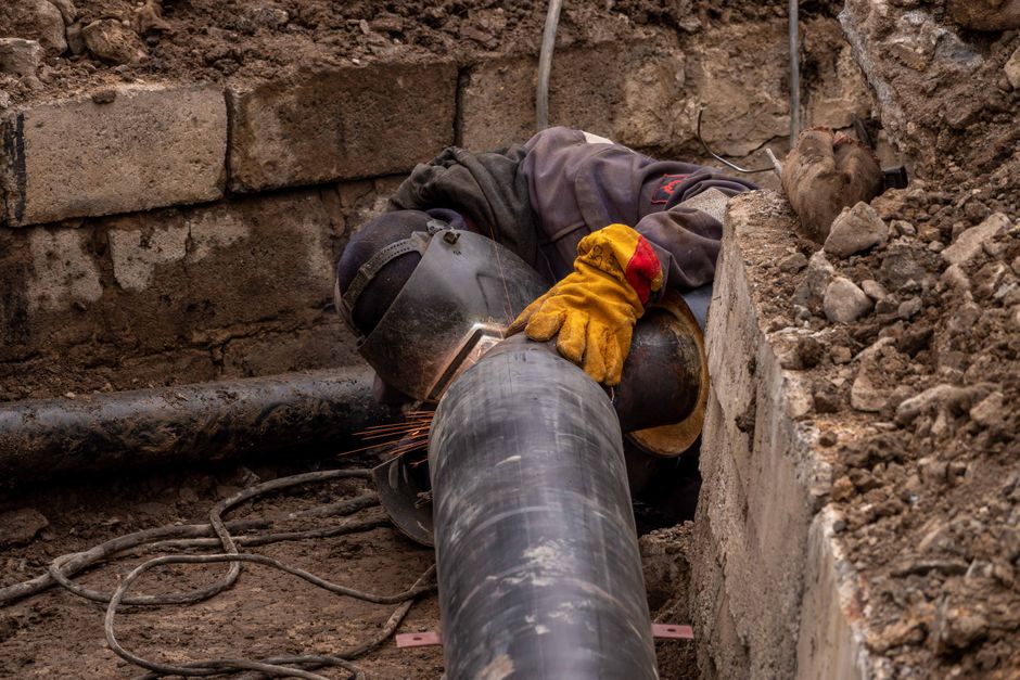 Close-up image of drainage pipes being repaired outdoors in a garden setting